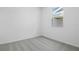 This bedroom features neutral carpet and a small window at 6385 Clover St, Lake Hamilton, FL 33851