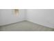 This bedroom features neutral carpet and a small window at 6385 Clover St, Lake Hamilton, FL 33851