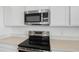 Close up of the stainless steel appliances and quartz countertops at 6385 Clover St, Lake Hamilton, FL 33851