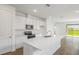 Open kitchen with quartz countertops, stainless steel appliances, and breakfast bar at 6385 Clover St, Lake Hamilton, FL 33851