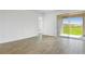 Bright and airy living room with tile flooring and sliding glass doors to the patio at 6385 Clover St, Lake Hamilton, FL 33851