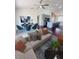 Bright open-concept living room featuring a modern kitchen, dining area, and comfortable seating at 738 Leonardo Ct, Kissimmee, FL 34758