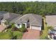 Aerial view of home showing mature landscaping and paver driveway at 789 Cielo Trl, Kissimmee, FL 34759
