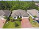 Aerial view of home showing mature landscaping and paver driveway at 789 Cielo Trl, Kissimmee, FL 34759