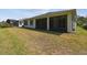 Backyard with a covered patio and green grass at 789 Cielo Trl, Kissimmee, FL 34759