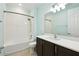 Clean bathroom featuring a shower-tub combo, vanity with quartz countertop, and modern lighting at 789 Cielo Trl, Kissimmee, FL 34759
