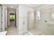 Modern bathroom featuring a glass-enclosed shower with tile surround and a view to a bedroom beyond at 789 Cielo Trl, Kissimmee, FL 34759