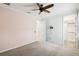 Cozy bedroom with a ceiling fan, doorway to closet, and soft, neutral-toned decor at 789 Cielo Trl, Kissimmee, FL 34759