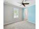Well-lit bedroom with neutral walls, a ceiling fan, and a window offering pleasant views at 789 Cielo Trl, Kissimmee, FL 34759