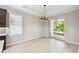 Bright dining room with hardwood floors, modern lighting, and sliding glass doors to the outdoor patio at 789 Cielo Trl, Kissimmee, FL 34759