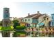 Beautiful waterfront property featuring multi-level architecture, tile roof, and inviting outdoor patio at 789 Cielo Trl, Kissimmee, FL 34759