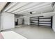 Spacious two-car garage with epoxy flooring and ample storage racks at 789 Cielo Trl, Kissimmee, FL 34759