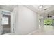 Bright hallway with hardwood floors leading to an open living space and bedrooms at 789 Cielo Trl, Kissimmee, FL 34759