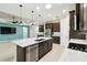 Open concept kitchen leading to the living area, stainless steel appliances, island at 789 Cielo Trl, Kissimmee, FL 34759