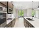 Chef's kitchen boasts an island with sink, stainless appliances, and sleek cabinetry at 789 Cielo Trl, Kissimmee, FL 34759