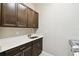 Well-lit laundry room featuring ample cabinets, quartz countertops and stainless steel sink at 789 Cielo Trl, Kissimmee, FL 34759