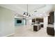 View of an open concept, well-lit living room and kitchen area with modern appliances and hardwood floors at 789 Cielo Trl, Kissimmee, FL 34759
