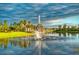Picturesque pond featuring a fountain centerpiece surrounded by lush green lawns and mature trees at 789 Cielo Trl, Kissimmee, FL 34759