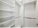 Well-organized walk-in closet with shelving and hanging rods for optimal storage solutions at 789 Cielo Trl, Kissimmee, FL 34759