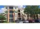 Beautiful condo building with palm trees, manicured landscaping, and convenient parking for residents and guests at 8296 Portofino Dr # 401, Davenport, FL 33896