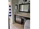 Bathroom vanity with dark cabinets and a shower with a striped curtain at 13 Dorset Dr, Kissimmee, FL 34758