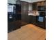 The kitchen has black appliances, plenty of counter space, and stylish brown backsplash at 13 Dorset Dr, Kissimmee, FL 34758