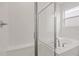 This pristine bathroom showcases a tiled walk-in shower and soaking tub with tile surround at 1654 Sugarbelle Cir, Mascotte, FL 34753