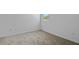 Comfortable bedroom featuring neutral carpet, white walls, and a window providing ample light at 1654 Sugarbelle Cir, Mascotte, FL 34753