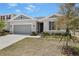 Charming single-story home with a two-car garage, stone accents, and well-maintained landscaping at 1654 Sugarbelle Cir, Mascotte, FL 34753