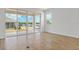 Bright room with sliding glass doors leading to the outdoors and wood-look tile flooring at 1654 Sugarbelle Cir, Mascotte, FL 34753