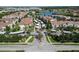 Scenic aerial view of the community featuring well-maintained landscaping, pool, lake, and buildings at 3301 Whitestone Cir # 203, Kissimmee, FL 34741