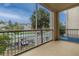 Relaxing screened balcony with views of palm trees, covered parking, and the community at 3301 Whitestone Cir # 203, Kissimmee, FL 34741