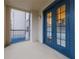 Enclosed balcony featuring tiled floor, screened windows, and a view of the community at 3301 Whitestone Cir # 203, Kissimmee, FL 34741