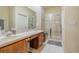 Bathroom featuring double sinks, a glass-enclosed shower, and a neutral color palette at 3301 Whitestone Cir # 203, Kissimmee, FL 34741