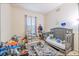 Bright bedroom featuring a neutral color scheme, window, and play area at 3301 Whitestone Cir # 203, Kissimmee, FL 34741