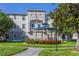 Exterior of a community building with manicured landscaping, a gazebo, and an American flag at 3301 Whitestone Cir # 203, Kissimmee, FL 34741