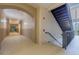 Well-lit hallway leading to stairs, featuring neutral walls and flooring at 3301 Whitestone Cir # 203, Kissimmee, FL 34741