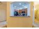 A view of the kitchen featuring wood cabinets, black appliances, and granite countertops, seen through an arched opening at 3301 Whitestone Cir # 203, Kissimmee, FL 34741