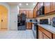 Kitchen with wood cabinets, granite countertops, and stainless steel appliances at 3301 Whitestone Cir # 203, Kissimmee, FL 34741