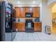 Traditional kitchen with granite countertops, wood cabinets, and stainless steel appliances at 3301 Whitestone Cir # 203, Kissimmee, FL 34741