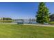 Picturesque view of a tranquil lake with a walking path, bench, and lush green lawn at 3301 Whitestone Cir # 203, Kissimmee, FL 34741