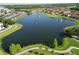 Scenic aerial view of a lake community featuring fountains, walking paths, and lush landscaping at 3301 Whitestone Cir # 203, Kissimmee, FL 34741