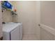Bright laundry room featuring modern washer and dryer, storage shelves, and neutral tile flooring at 3301 Whitestone Cir # 203, Kissimmee, FL 34741