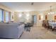 Inviting living room featuring carpet, a sofa, a decorative chair, and a dining area at 3301 Whitestone Cir # 203, Kissimmee, FL 34741