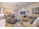 Inviting living room featuring modern furniture, neutral tones, and a view into the adjacent dining area and kitchen at 3301 Whitestone Cir # 203, Kissimmee, FL 34741