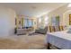 Bright living room area with a comfortable sofa, patterned chair, and view into an adjacent bedroom at 3301 Whitestone Cir # 203, Kissimmee, FL 34741