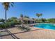 Community pool area with lounge chairs, shade, and palm trees creating a relaxing atmosphere at 3301 Whitestone Cir # 203, Kissimmee, FL 34741