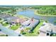 Aerial view of the property near a serene lake and mature trees at 363 Bella Cortina Dr, Kissimmee, FL 34759