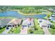 Aerial view of property with solar panels near a tranquil pond and lush greenery at 363 Bella Cortina Dr, Kissimmee, FL 34759