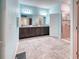 Bathroom featuring double sinks, a glass shower and tiled floors creating a functional space at 363 Bella Cortina Dr, Kissimmee, FL 34759